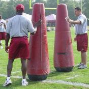 Coaches hold these heavy post to simulate defensive players during the RB drills.