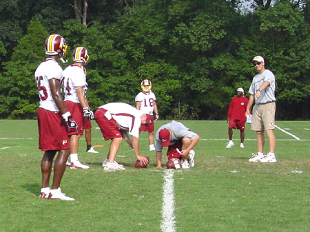 Redskin coaches take the hands-on approach.