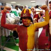 This young Redskins fan shows off the home team colors and his muscles for all the crowd (and cheerleaders) to see.