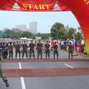 A line of Marines hold off the crowd of runner before the Marine Corps Marathon commenced at 8:30 a.m. 