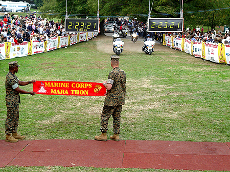 Two marines await the arrival of the first Marathon runner.