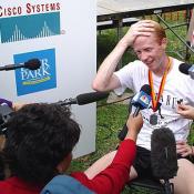 An exhausted Sherry talks to the press about winning the Marathon.