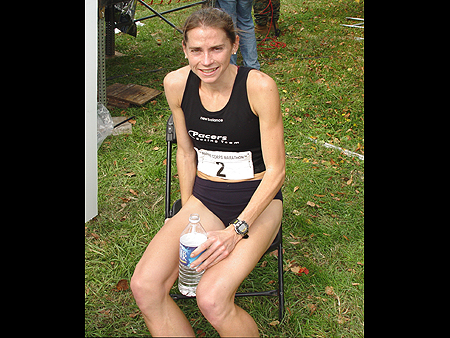 The first woman to cross the finish line finally gets a chance to relax after running for over two hours.