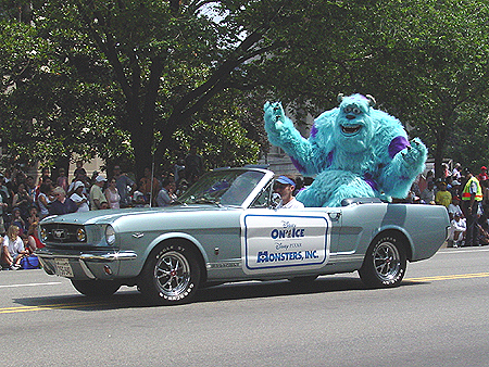 Sulley from the movie MONSTERS INC. waves to the crowd