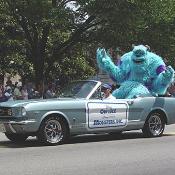 Sulley from the movie MONSTERS INC. waves to the crowd