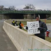Man holds sign - BUSH = HITLER