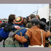 Protesters keep warm with a group hug.