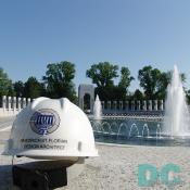 The hard hat of Friedrich St. Florian, World War II Memorial Design Architect. In the background the Memorial Plaza and Rainbow Pool are the principal design features of the Memorial, unifying all other elements. 