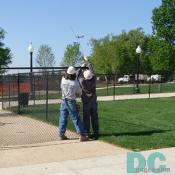 Workers take down the fence from the perimeter of the World War II Memorial. 