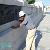 Mason Antonio cleans off excess granite.