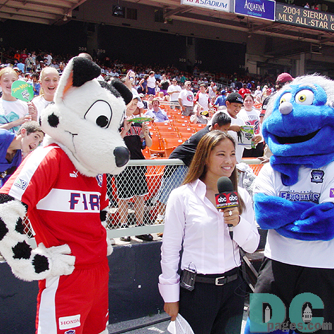 Behind the ABC SPORTS reporter and the two mascots from Chicago Fire and San Jose Earth Quakes, kids were trying to show up on a broadcast TV program.  