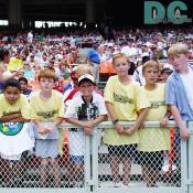 In the extreamly hot temperature, soccer fan kids were posing for the camera. 
