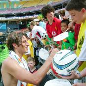 With a nice smile, Columbus Crew Frankie Hejduk was signing on a soccer ball. 