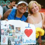 With their handmade "I LOVE LANDON" poster, cute girls gave smiles to the camera. 