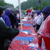More volunteers help hand out yogurt to all the participants in the race