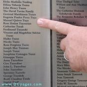 Luke Wilbur points to his grandparents: Eugenia Prados Perez Tuya and her husband Manuel Quiros Tuya. Donated by the Beasley family. If your family immigrated to the U.S. you can add their name to the wall. Click here for information