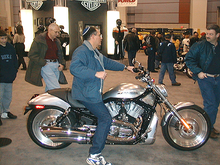 My personal favorite Harley, the 2004 VRSCB V-Rod, it has a v-twin, black frame, stainless steel finish to it's body work, and adjustable handlebars.