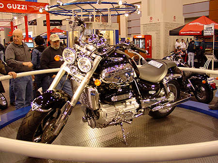 The TRIUMPH ROCKET III, is duel head lighted, first production motorcycle to break the 2-litres barrier. Its unique fuel-injected, twelve-valve, longitudinally-mounted, in-line three-cylinder engine has a cubic capacity of 2,294cc  140 cubic inches  and uses the same size pistons as a ten-cylinder American muscle car.  
