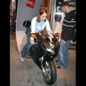 Oh, here she is again modeling a new asphalt black Ducati 749R. 