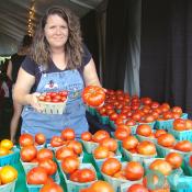 This farmer displays a variety of locally grown Montgomery County tomatoes.