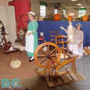 These ladies are hand spinning wool from antique foot powered machines. That must be a good workout.