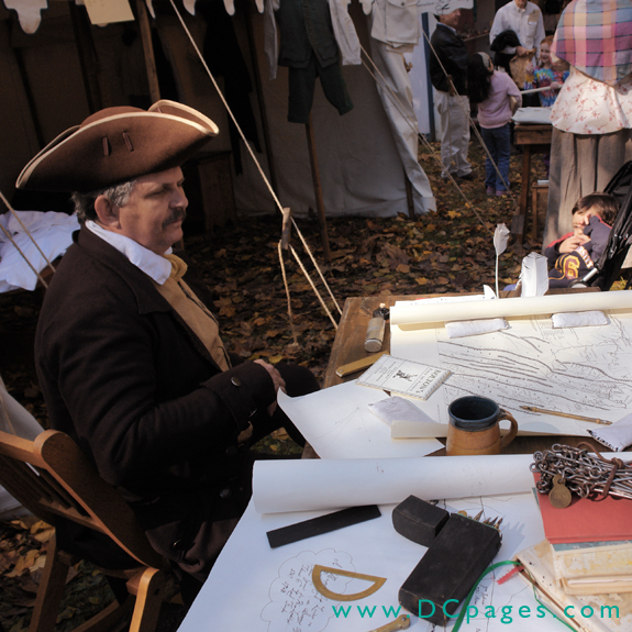 Colonial surveyor, Paul Parish displays maps and charts of the colonia area, as well the tools used to create the maps.