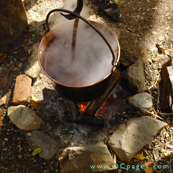 This copper dye pot contains cochineal, a red dye obtained from insects. The pot is held over a fire to heat the dye.
