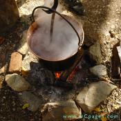 This copper dye pot contains cochineal, a red dye obtained from insects. The pot is held over a fire to heat the dye.
