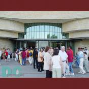 Visitors wait in a long line to enter through the National Museum of the American Indian's East entrance.