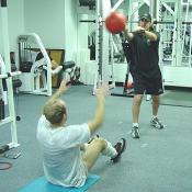 The object of this drill is to throw the ball to the trainer while doing a sit-up.
