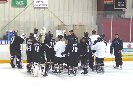Players gather around to listen to instructions from the coaching staff.