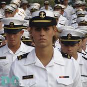 Female Naval Academy cadet marches onto Navy-Marine Corps Memorial Stadium.