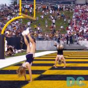 Navy Cheerleaders tumbling on the endzone after a Navy touchdown.
