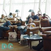 Redskins fans watch Draft Day coverage in sleek leather seats.