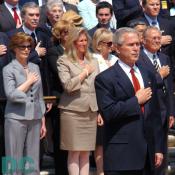 President George W. Bush, First Lady Laura Bush, and other Americans place their hand over his heart while Taps plays at the Tomb of the Unknowns during Memorial Day ceremonies, May 29, 2006 at Arlington National Cemetery.