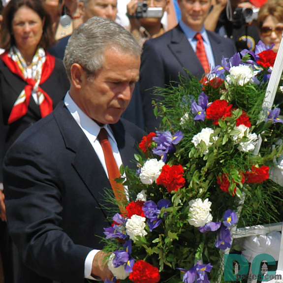 Closeup of President George W. Bush placing a ceremonial wreath at the Tomb of the Unknowns.