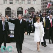 Emerging from their armored limousine, President George W. Bush and first lady Laura Bush wave to well wishers as they prepare to travel 1.7-miles along the inaugural parade route.
