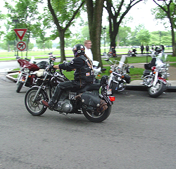 A lone rider thunders by, trying to catch up to the rest of his gang.