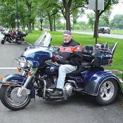 A blue 3 wheeled Harley Davidson.