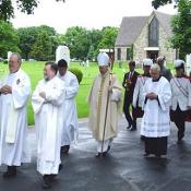 Bishop and deacons exit a Memorial Day dedication ceremony.