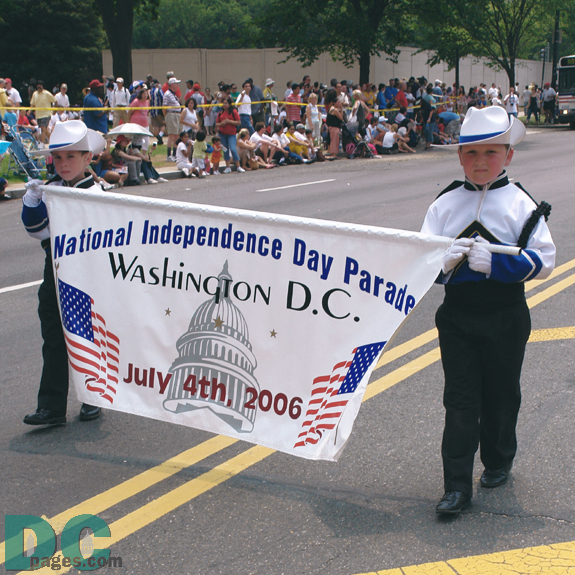 Two young boys carry the 'National Independence Day Parade' banner.