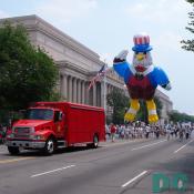 Red rescue truck and bald eagle balloon in back