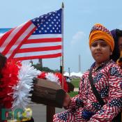 Sikh boy wrapped up in red, white, and blue