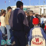 Washington Nationals' Inaugural Home Opener - Many fans were sporting old Washington Senators jackets, jerseys, hats, and other memorabilia. Here a father and son wait in line to attend their first baseball game together.