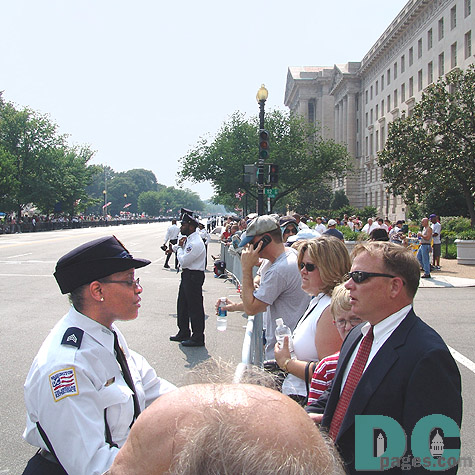 Processional watchers are greeted by the increased security along the motorcade route.