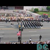 The U.S. Marines marching while receiving cheers from the crowd.