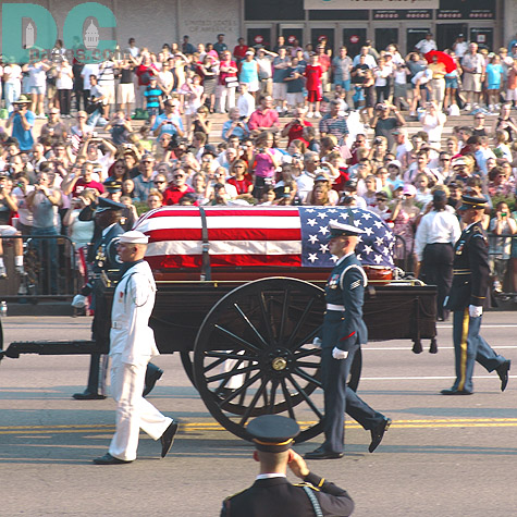 The crowds line the streets to watch the American flag adorned casket proceed by. One detail of the service that weighed heavy on everyones mind was the actual weight of the casket. Tipping the scales at over 700 pounds, the marble inlayed coffin certainly proved a challenge for the The Old Guard Soldiers.