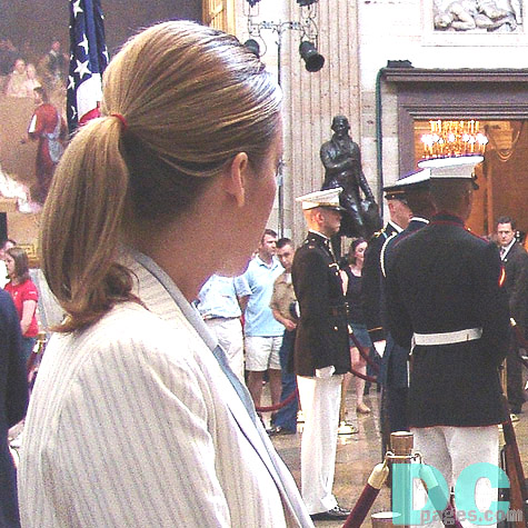 A woman looks on at the Former President's viewing.