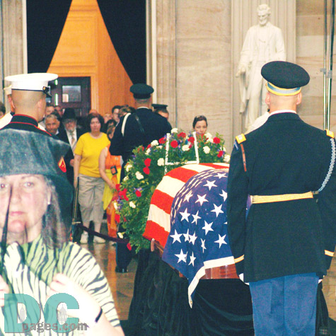 A close up of the casket, adorned with wreathes.
