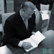 Al Gore writes a note to Ralph Nader on his book's inside cover.